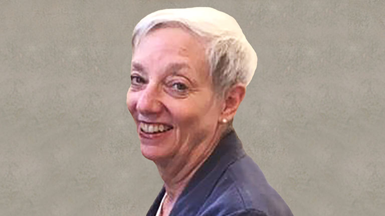 Headshot of a female account manager wearing a blue blazer.