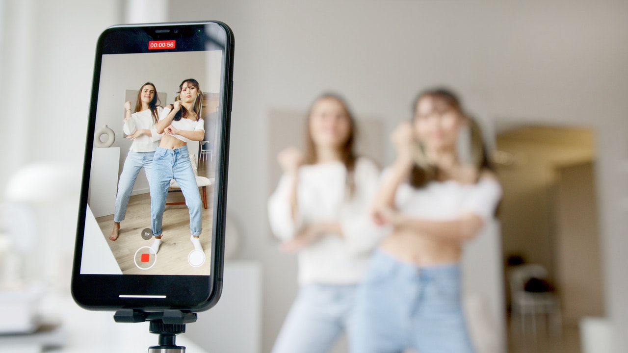 Two women dancing for TikTok video.