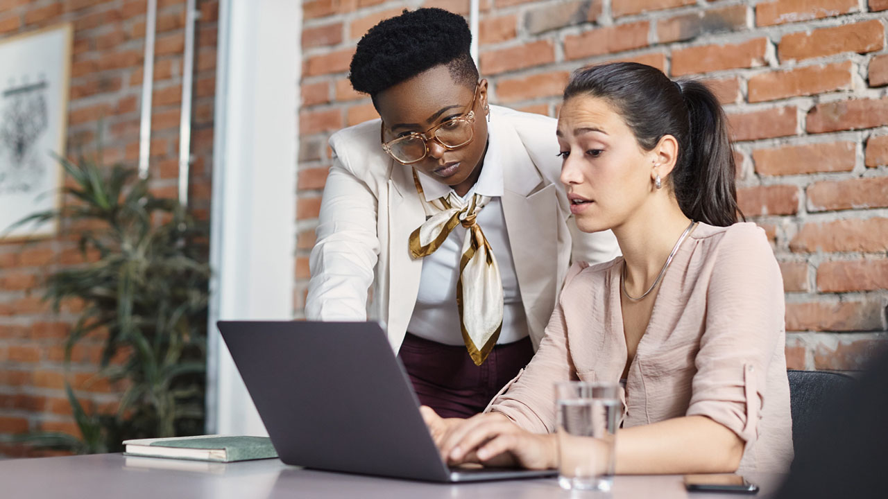 Two marketing experts discussing company email content marketing strategy.